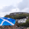 A Scottish flag flying next to Oban Castle